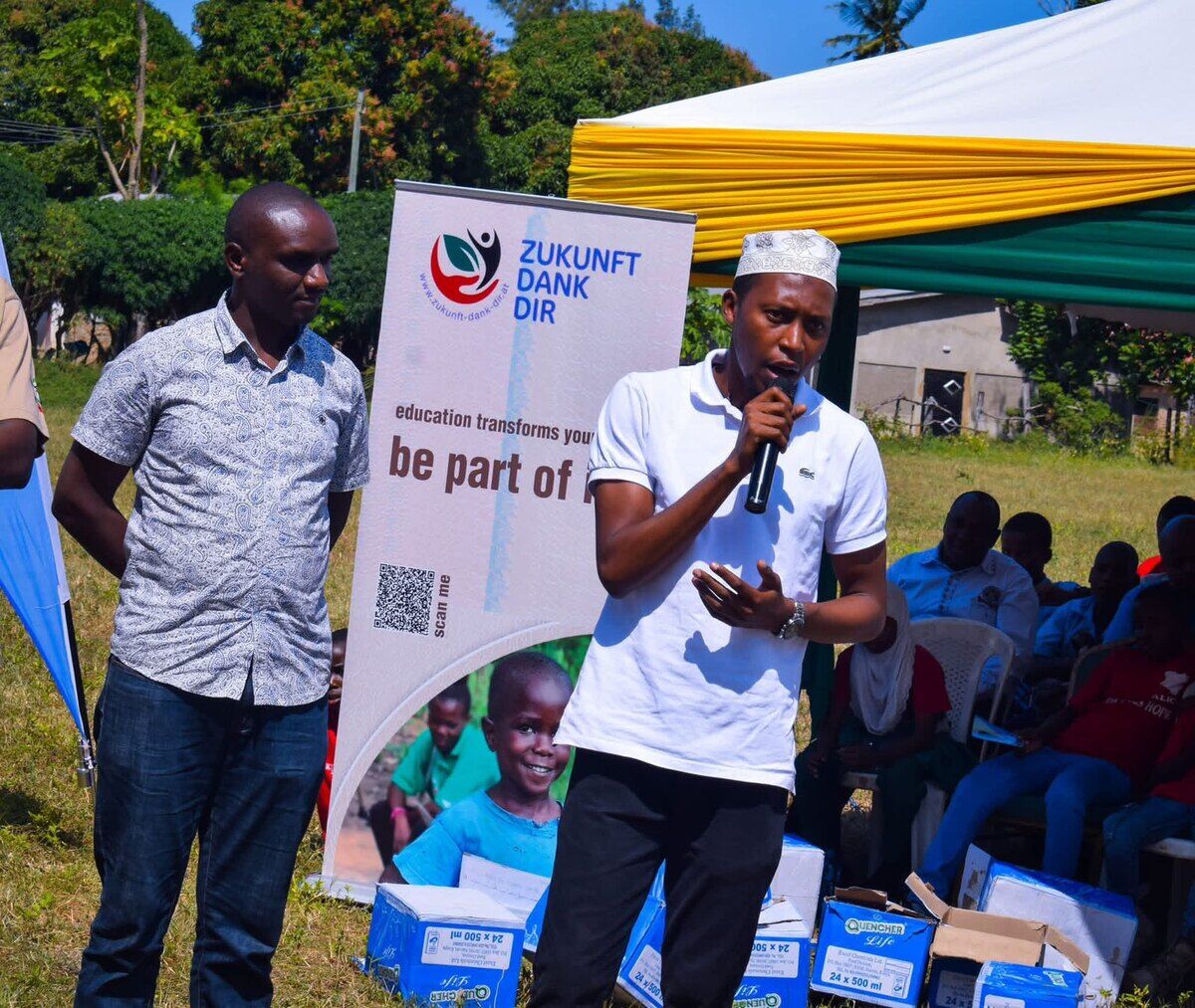 Addressing a community gathering at an outdoor public event