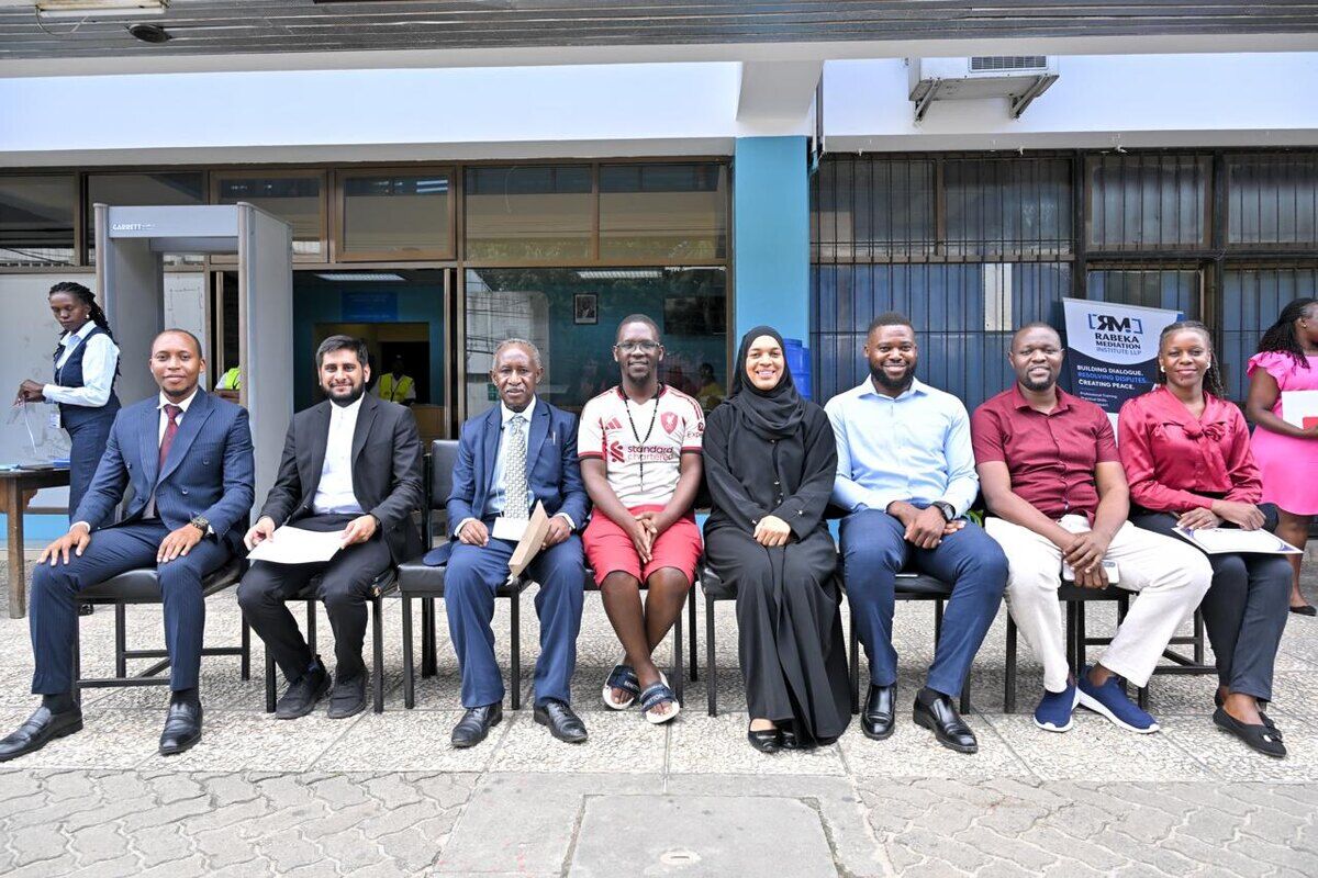 A panel of mediators seated at a community dialogue event